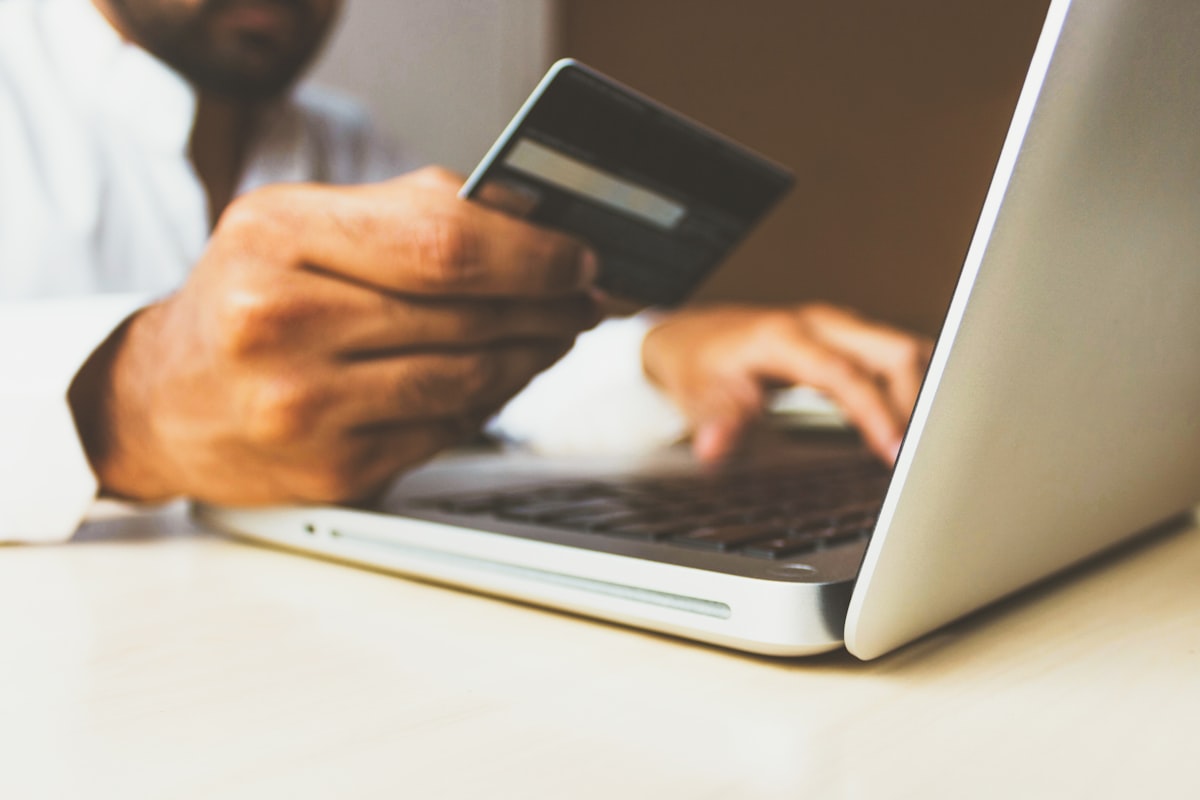 Person completing an online checkout on a laptop