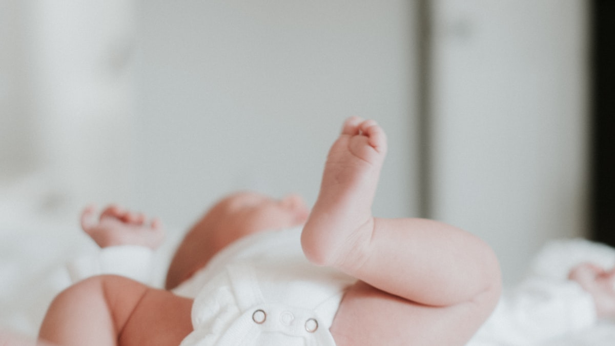 Baby wearing a white onesie