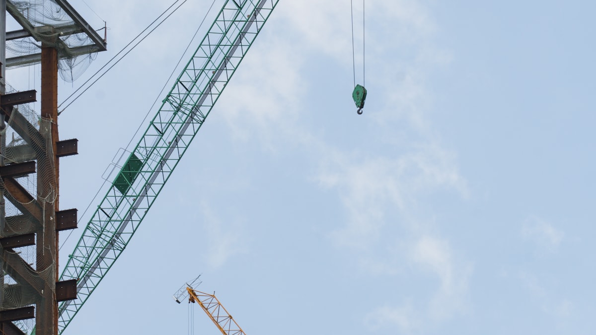 Construction cranes on a Dubai skyline under development