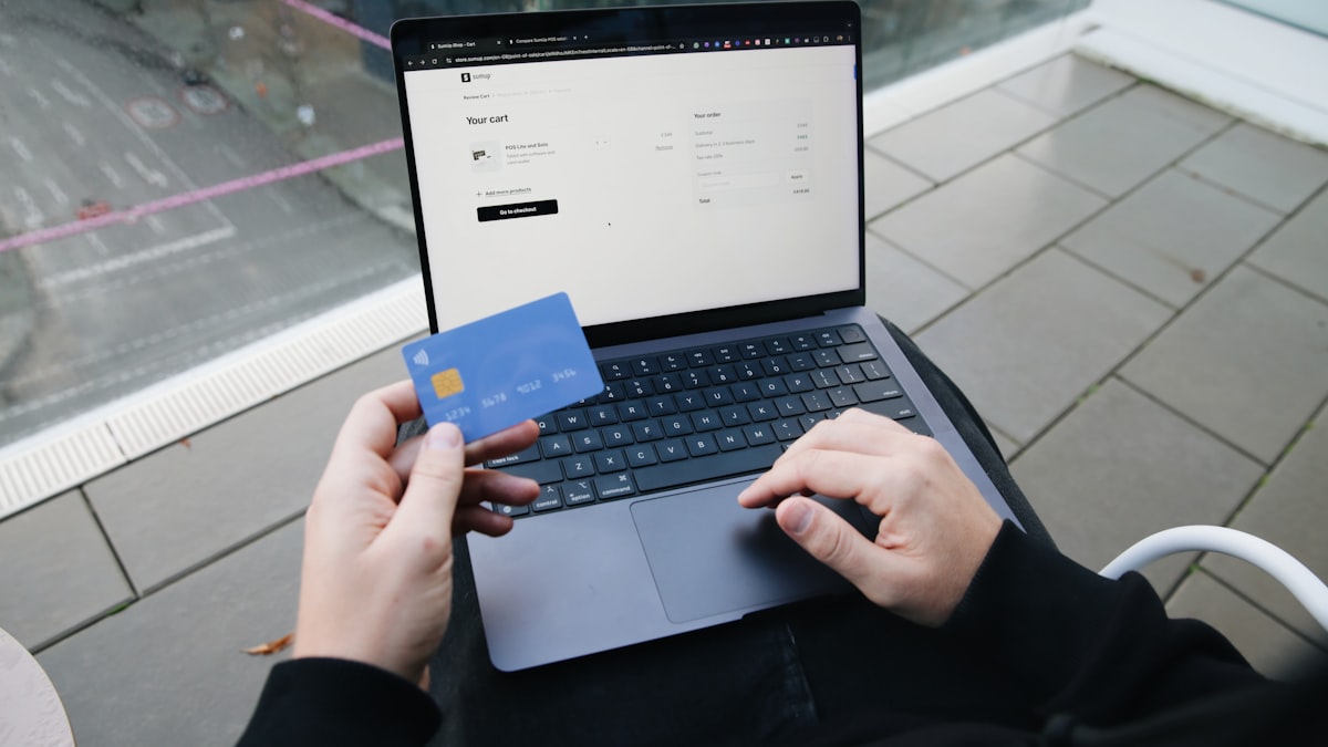 Person checking out online holding a credit card