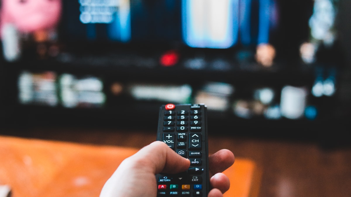 TV remote control in front of a streaming screen